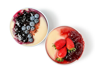 Bowls of tasty semolina porridge with blueberry and strawberry jam on white background