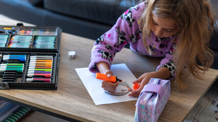 "Girl in Pink Pajamas Drawing in the Living Room"