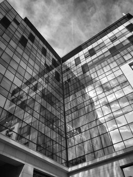 Monochrome photo of corner glass building