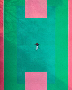 Top of view of woman laying on spacious sport field