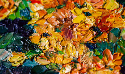 Texture of an oil painting in yellow and orange tones drawn with a palette knife