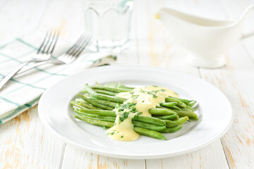 green bean with mushroom sauce on white table, selective focus. Vegetarian, healthy, clean eating.