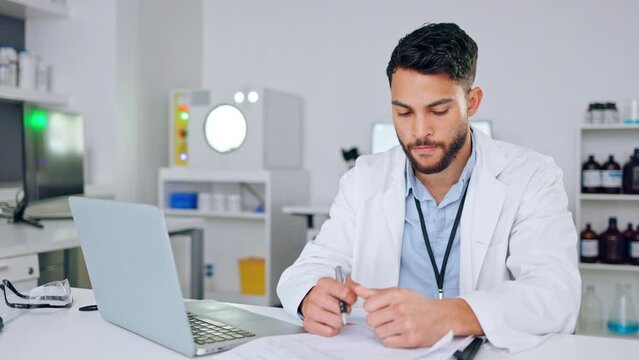 Frustrated, angry and stressed scientist hitting his laptop in anger after getting bad test results in a lab. Medical worker and researcher depresed and upset after a failure in science experiment