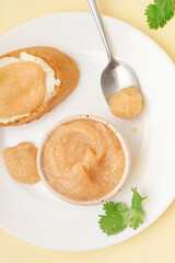 Bowl with caviar of capelin and canape on beige background