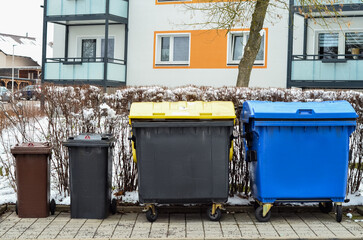 Naklejka premium View of garbage containers in city on winter day