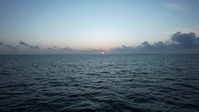 Sunrise fly over the waters of the Gulf of Mexico. Located in Cancun, Mexico. Aerial 4K drone video