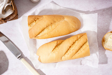 Halves of fresh baguette on white background