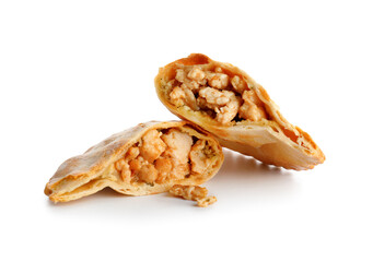 Halves of baked meat empanada on white background