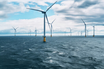 Wind turbines in a row in the ocean. Generative ai