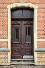 View of brick building with wooden door