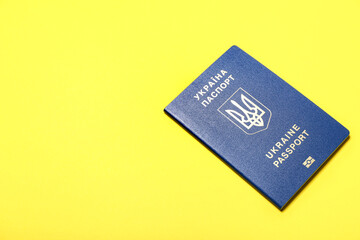 Ukrainian passport on yellow background