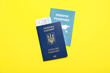Ukrainian and immune passports on yellow background