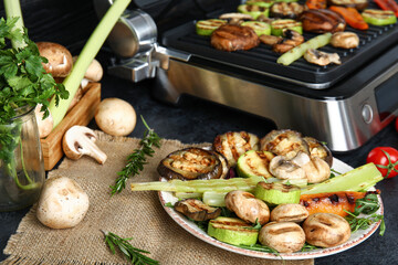 Plate with tasty grilled vegetables on table