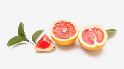 Composition with pieces of juicy grapefruit and plant leaves isolated on white background