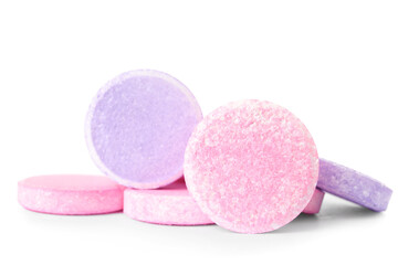 Pink and lilac soluble tablets isolated on white background