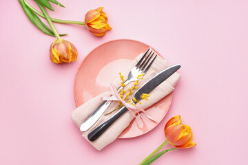 Table setting with beautiful tulip flowers on pink background