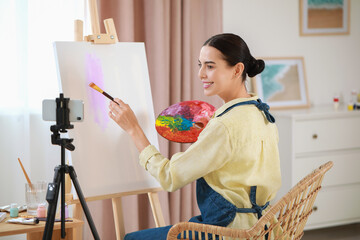 Teacher conducting online painting lesson at home. Time for hobby