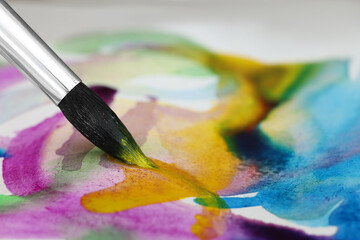 Obraz premium Painting with bright watercolor on paper, closeup. Space for text