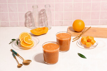 Glasses of healthy smoothie and ingredients on table