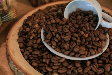 Roasted coffee beans in white cup. retro style toned, copy space. Background and texture of roasted coffee beans