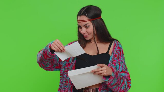 Pretty young hippie woman open envelope take out letter reads it feel happy. Girl career growth advance promotion, bank loan approve, monetary award, long-awaited invitation great news, lottery win