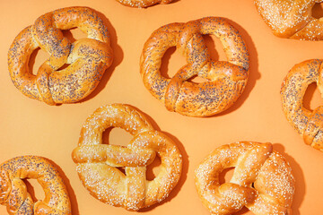 Delicious pretzels on color background