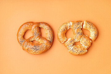 Fresh pretzels on color background