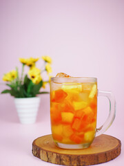 bul bul ice or fruit ice drinks filled with pieces of pineapple and papaya. Indonesian fruit ice