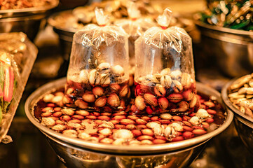 Pickled cockles in fish sauce, put in a container for sale at Nong Mon Market, Bang Saen, Thailand.