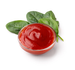 Bowl of tasty ketchup and spinach leaves isolated on white background