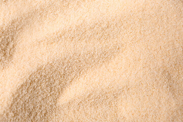 Raw semolina as background, closeup