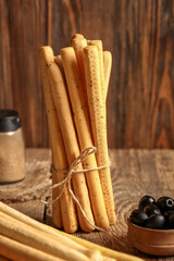 Bunch of tasty Italian Grissini on wooden background