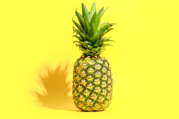 Fresh ripe pineapple on yellow background
