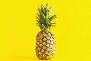 Fresh ripe pineapple on yellow background