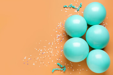Blue balloons, ribbons and serpentine on orange background