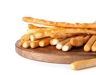 Wooden board with tasty Italian Grissini isolated on white background, closeup