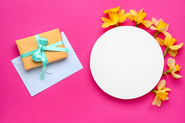Beautiful narcissus, envelope, gift box and round blank card on color background