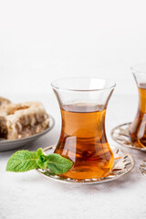 Glass of Turkish tea on white table