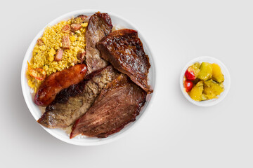 Marmitex with meat, rice, beans, crumbs and zucchini in a white bowl - packed lunch - Brazilian Food - top view.
