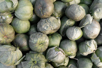 Fototapeta na wymiar Close up of some green tomatoes in a street market stall