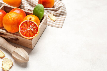 Box with tasty blood orange fruits on white background
