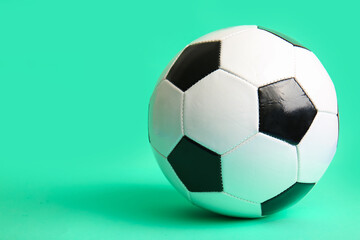 Soccer ball on turquoise background