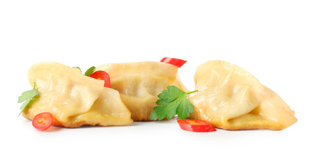 Tasty Chinese jiaozi, red pepper and parsley on white background