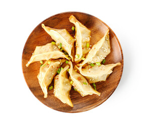 Plate with tasty Chinese jiaozi, green onion and sesame on white background