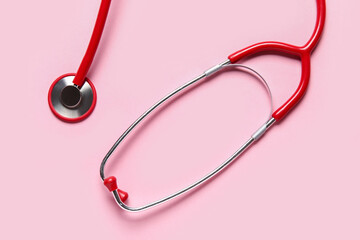 Modern stethoscope on pink background