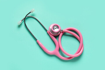 Modern stethoscope on turquoise background