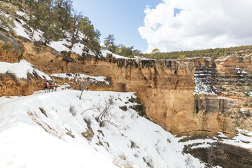 Fototapeta na wymiar Hikers at the first tunnel on snow covered Bright Angel Trail, Grand Canyon, Arizona, USA