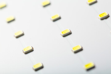 Close up of white LED panel with yellow light. Soft focus background. Energy eco saving bulb.