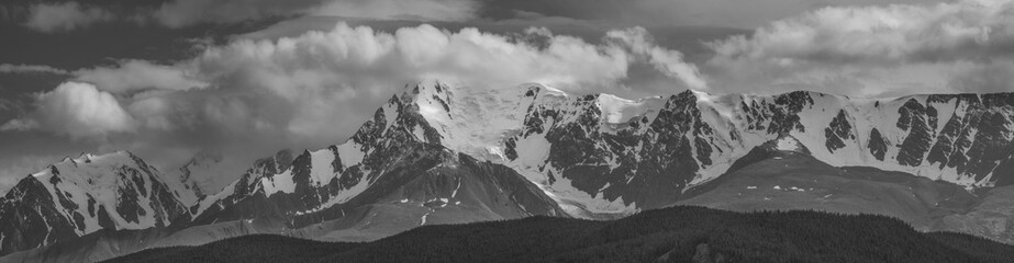 Black and white landscape, panorama. Snow-capped mountain peaks. Traveling in the mountains, climbing.