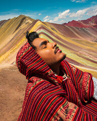 peruvian at the rainbow montain vinicunca peru with poncho - obrazy, fototapety, plakaty